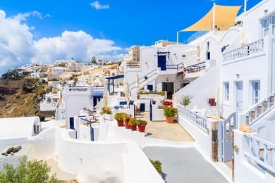 view of imerovigli village with typical white greek houses on santorini island, greece.
