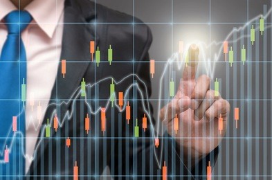 businessman pointing or touching the trading graph of stock market on the virtual screen on dark background, business stock market concept