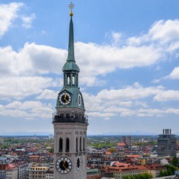 aerial panoramic view from the top of observation deck on the city hall to st. peter's church, a roman catholic church, under blue sky with clouds on background, munich (munchen), bavaria, germany