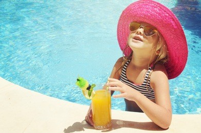 little girl in watter pool in the summer day