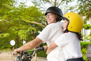 father and daughter traveling on motorcycle 