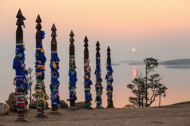 serge poles at cape burhan at sunrise. olkhon island, lake baikal, irkutsk region, russia.