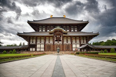 the  todai-ji temple in nara, japan, with gathering storm clouds. 