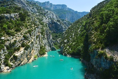 panorama of the canyon in the verdon gorge in southern france with the river by the color blue and boats and canoes tourists