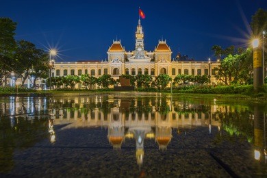 ho chi minh city hall in ho chi minh city, vietnam at night. it is known as ho chi minh city people's committee head office and was built in 1902-1908.