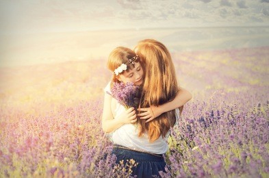 lovely young woman and a little girl in a lavender field