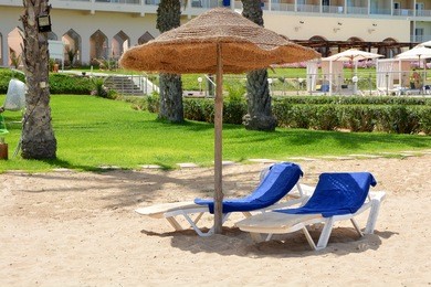 parasols and sun loungers on a sandy beach in sousse.tunisia