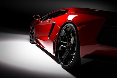 red fast sports car in spotlight, black background. shiny, new, luxurious. 3d rendering