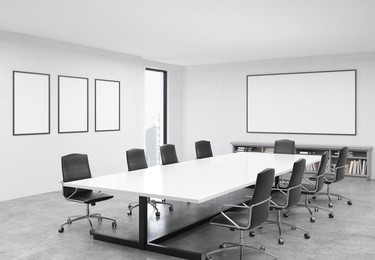 concrete conference room interior with table, chairs, blank whiteboard, picture frames and city view. mock up, 3d rendering
