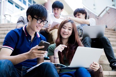 group of happy teen high school students outdoors