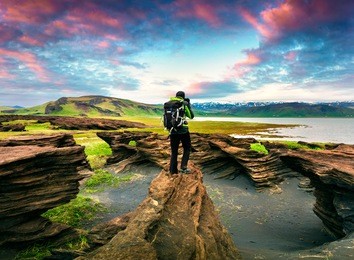 photographer take a picture of sunset on the volcanic origin peninsula - dyrholaey , south coast of iceland, near vik village, europe. artistic style post processed photo.
