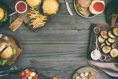 frame from various food, burgers, salad, roquefort cheese and vegetables cooked on the grill, top view. outdoors food concept