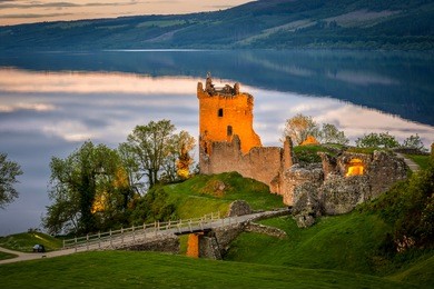 closeup view of urquhart castle. the castle sits beside loch ness, near inverness and drumnadrochit, in the highlands of scotland. only the tower of the castle is in focus; the rest is blur.