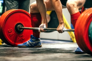 closeup of powerlifter to prepare exercise deadlift during competition of powerlifting