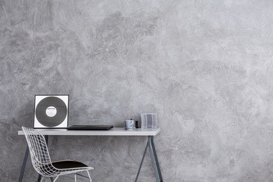 cropped shot of a minimalistic desk facing the gray wall