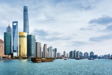view from the bund in shanghai, china. the shanghai tower, the shanghai world financial center and other skyscrapers of downtown are visible at left. self-propelled barges on the huangpu river.