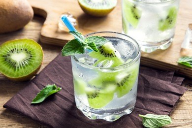 kiwi drink (cocktail) with mint and ice in glasses close up