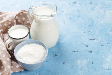 dairy products on stone table. sour cream and milk. view with copy space