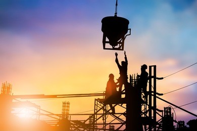 silhouette construction workers work on a team with high security standards of the world over blurred pastel background .industry,business, standards, training, specific, professional license, safety