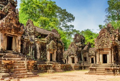 view of ancient thommanon temple in amazing angkor, siem reap, cambodia. mysterious thommanon nestled among rainforest. blue sky in background. enigmatic angkor is a popular tourist attraction.