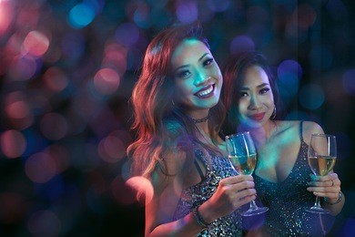 two lovely vietnamese girls with champagne glasses