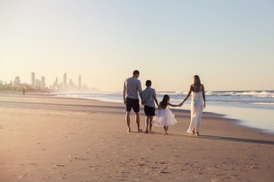 family of four portrait on the beach, soft selective focus, toning