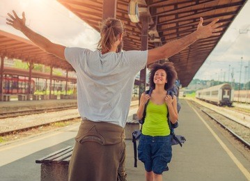 man meeting his girlfriend from her trip at the train station