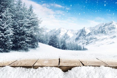 winter blue landscape of alps and brown old table of wood and snow place 