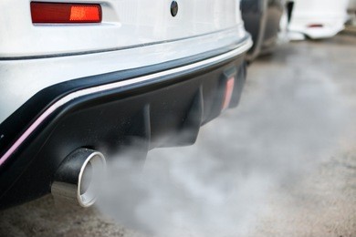 combustion fumes coming out of car exhaust pipe