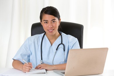 cheerful asian female doctor looking at the camera