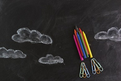 rocket made out of crayons. on a blackboard