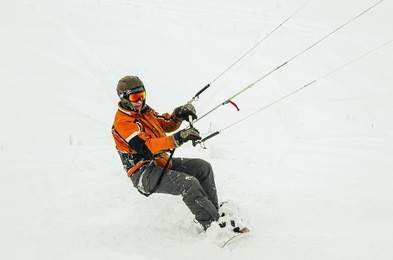 snowboarder riding a kite