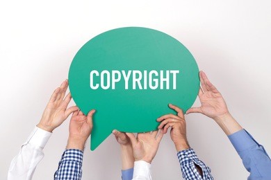 group of people holding the copyright written speech bubble