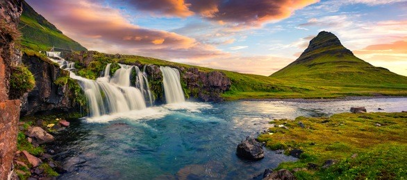 summer sunset on famous kirkjufellsfoss waterfall and kirkjufell mountain. colorful evening panorama of snaefellsnes peninsula, iceland, europe. artistic style post processed photo.