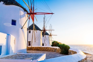 famous mykonos town windmills in a romantic sunset, mykonos island, cyclades, greece
