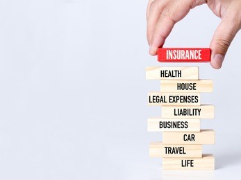businessman building insurance concept with wooden blocks