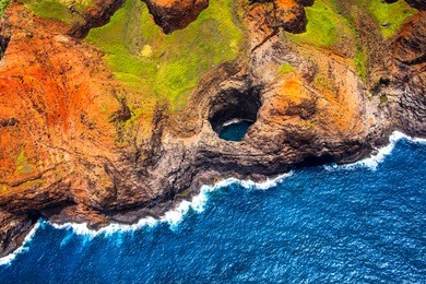 aerial view of na pali coastline open ceiling cave from helicopter, kauai, hawaii, usa