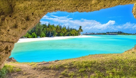 panoramic view through cave of natural sea beach under summer blue sky, travel holiday concept 