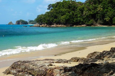 tropical island. a part of beautiful kapas island, malaysia with unique formation rocks, reflection and blue sky, 
