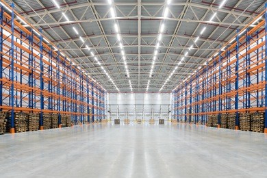 empty huge distribution warehouse with high shelves and pallet