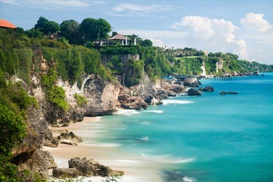 scenic sea landscape, bali. high cliff on tropical pantai beach in bali, indonesia. tropical nature of bali, indonesia. beautiful blue sea water, white sand beach and green tropics of bali shoreline
