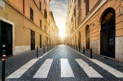 sunrise over street with pedestrian crossing in rome 