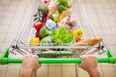 man with trolley full of products in supermarket top view