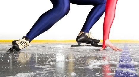 speed skater at the starting line on an indoor ice rink