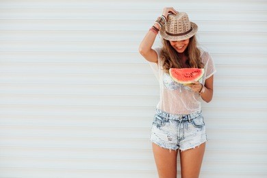 young pretty women holding a slice of watermelon in hands and smiling happy, summertime concept and mood, over an white background with lines