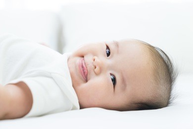 portrait of a newborn asian baby on the bed 