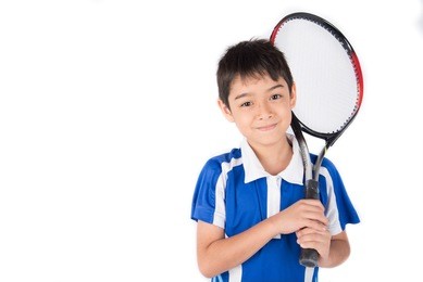 little boy playing tennis racket and tennis ball in hand