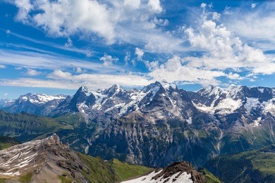 panorama view of the famous peaks: eiger, monch and jungfrau of swiss alps on bernese oberland, form top of schilthorn, canton of bern, switzerland.