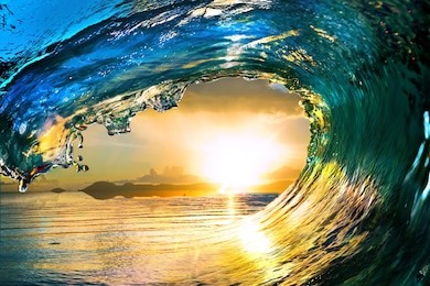 surfing colored ocean wave falling down at sunset time