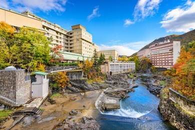 jozankei, japan inns and river skyline during the autumn.